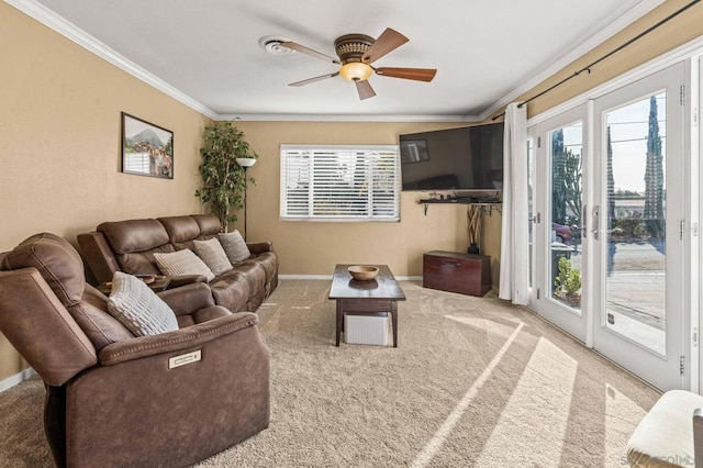 carpeted living room featuring ornamental molding and ceiling fan