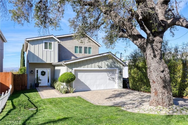 view of front of property with a garage and a front lawn