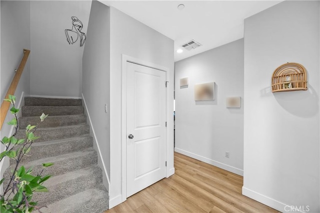 stairs featuring hardwood / wood-style floors