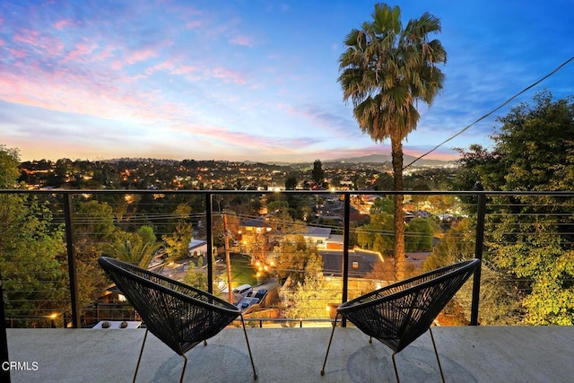 view of balcony at dusk