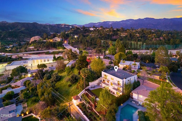 aerial view at dusk featuring a mountain view