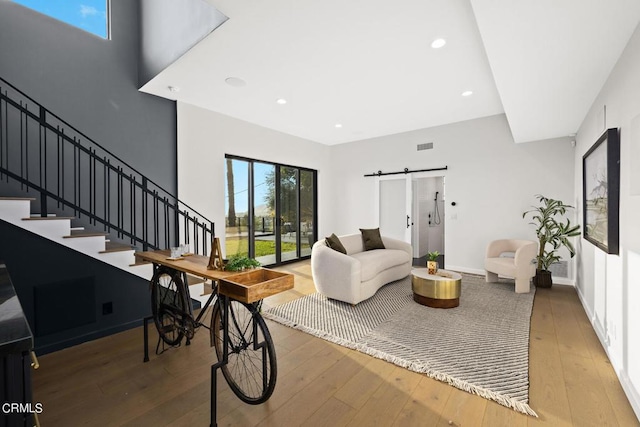 living room featuring hardwood / wood-style floors and a barn door