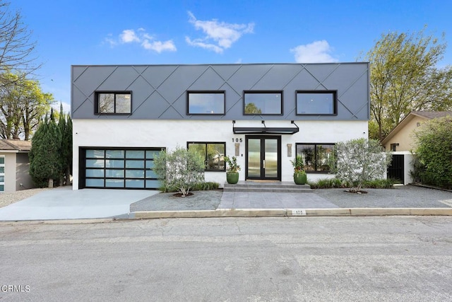 view of front facade with a garage and french doors