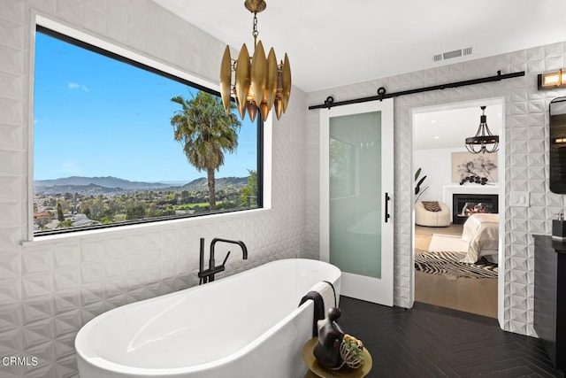 bathroom with a washtub, a mountain view, and parquet flooring