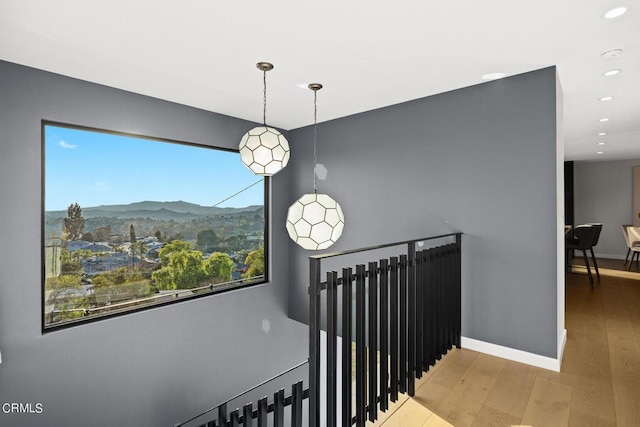 stairway featuring a mountain view and hardwood / wood-style floors