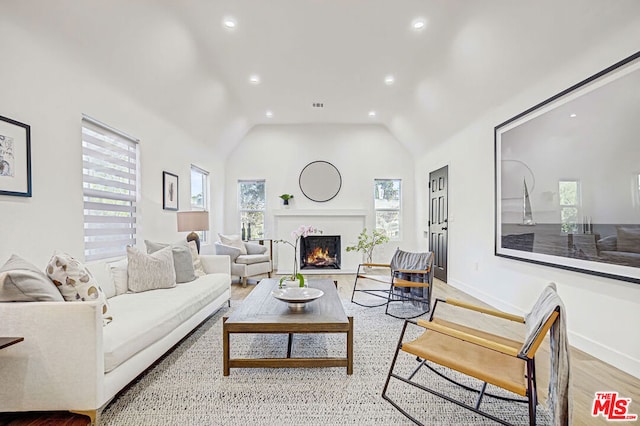 living room with vaulted ceiling and light hardwood / wood-style floors