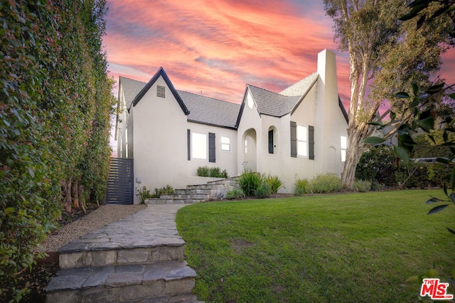 view of front of property with a lawn