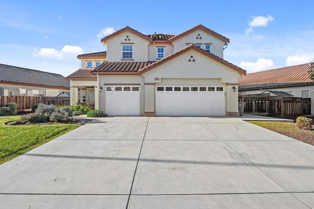 mediterranean / spanish house featuring a garage and a front lawn