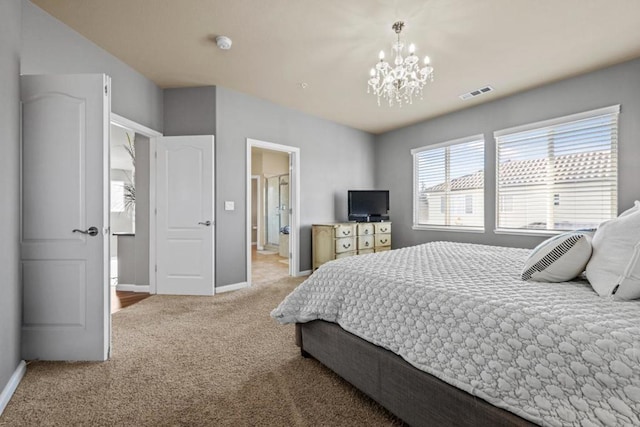 carpeted bedroom featuring a chandelier