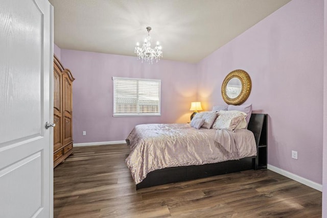 bedroom featuring dark hardwood / wood-style floors and a notable chandelier