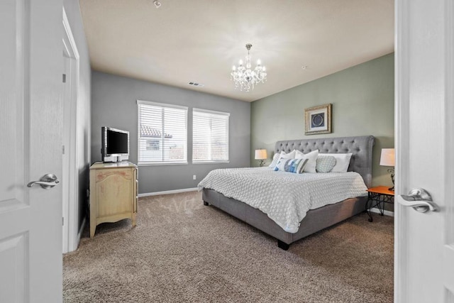 carpeted bedroom with an inviting chandelier