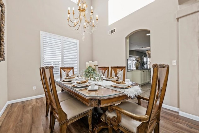 dining room featuring hardwood / wood-style flooring and an inviting chandelier