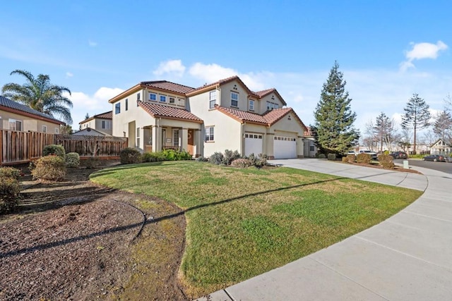 mediterranean / spanish house with a garage and a front yard