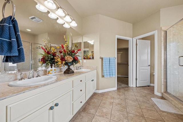 bathroom with tile patterned flooring, vanity, and a shower with shower door