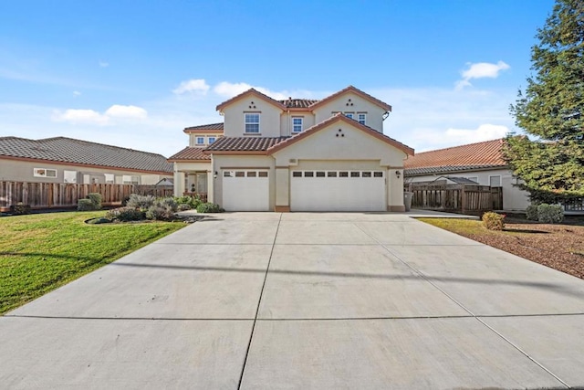 mediterranean / spanish house featuring a garage and a front yard