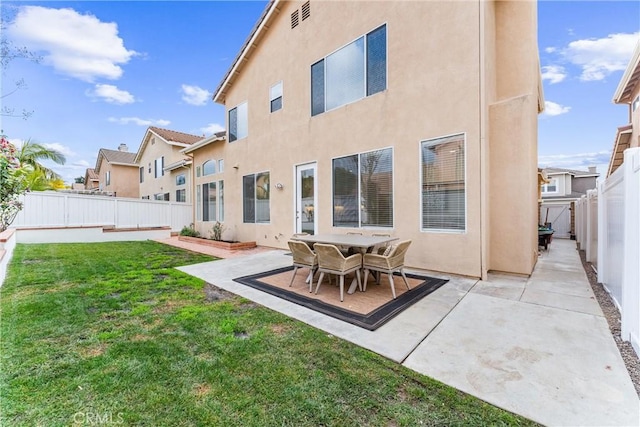 back of house featuring a yard and a patio area