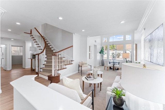 living room featuring crown molding and light wood-type flooring