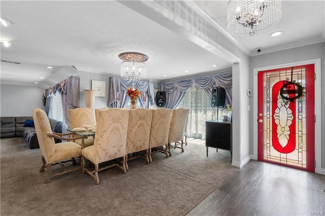 dining area with an inviting chandelier, crown molding, and dark hardwood / wood-style floors