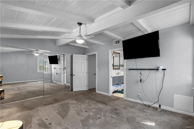 garage featuring carpet, a closet, vaulted ceiling with beams, ceiling fan, and ensuite bathroom