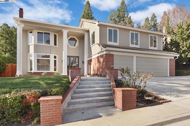 view of front of house with a garage and a front yard