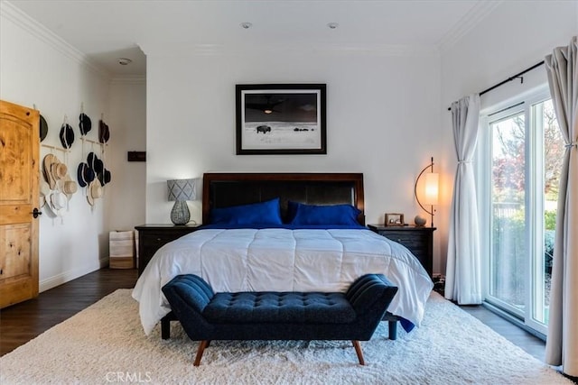 bedroom featuring crown molding, dark hardwood / wood-style floors, and access to outside