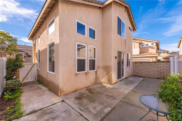 rear view of property featuring a patio