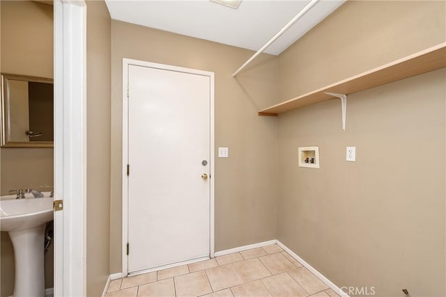 laundry area with washer hookup, sink, and light tile patterned flooring