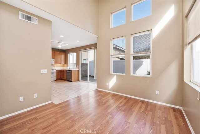 unfurnished living room with plenty of natural light and light hardwood / wood-style floors