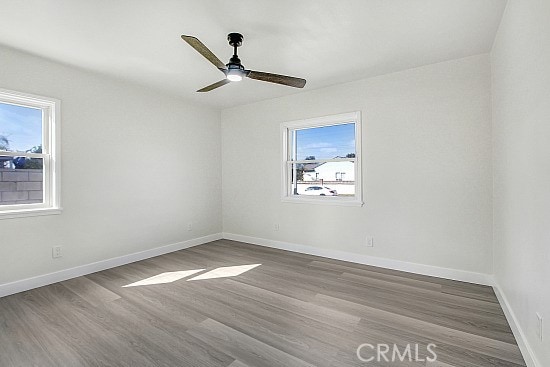 unfurnished room featuring ceiling fan and wood-type flooring