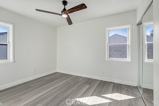 unfurnished room with light hardwood / wood-style flooring and ceiling fan