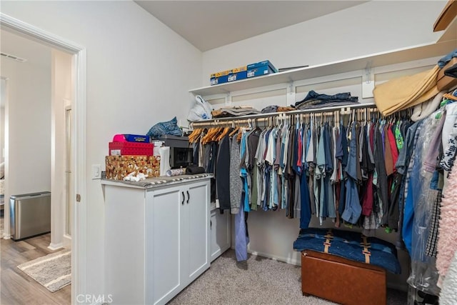 spacious closet featuring light hardwood / wood-style floors