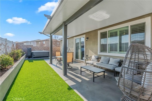 view of patio / terrace featuring a hot tub and an outdoor living space