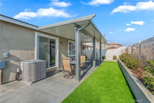 rear view of house with a patio, a yard, and central AC unit