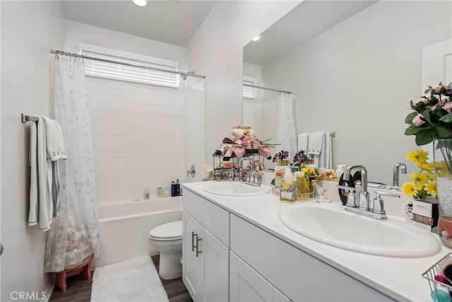 full bathroom with vanity, toilet, and shower / tub combo