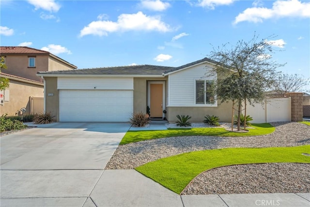 ranch-style home featuring a garage, concrete driveway, and stucco siding