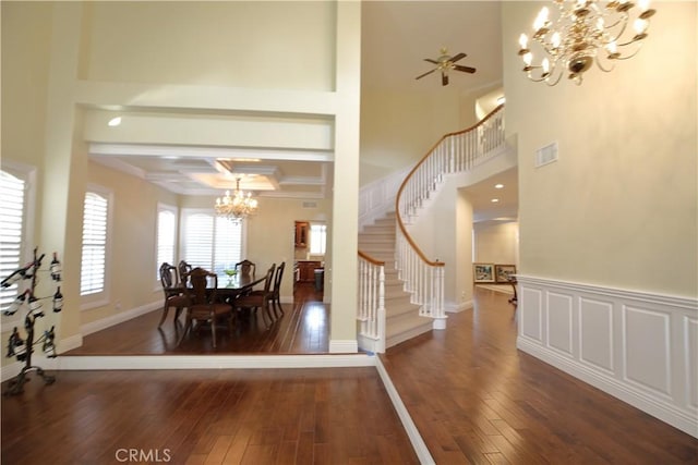 dining area featuring ornamental molding, beam ceiling, dark hardwood / wood-style flooring, and ceiling fan with notable chandelier