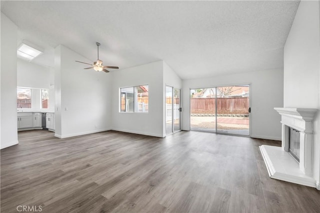 unfurnished living room with wood-type flooring, lofted ceiling, and ceiling fan