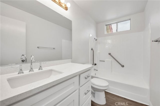 full bathroom featuring shower / bathtub combination, vanity, toilet, and hardwood / wood-style floors