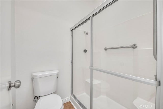 bathroom with toilet and walk in shower