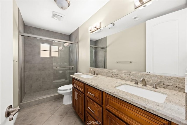 bathroom featuring vanity, an enclosed shower, tile patterned floors, and toilet