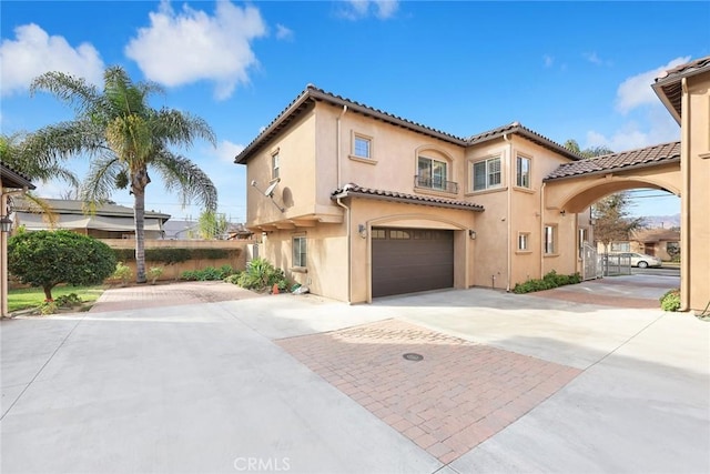 mediterranean / spanish home with a garage