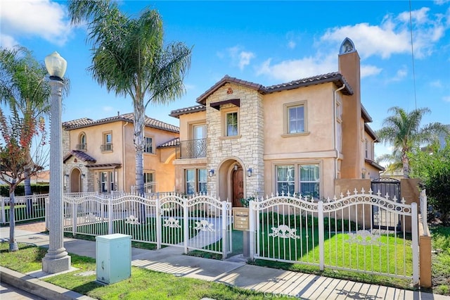 mediterranean / spanish home with a balcony and a front yard