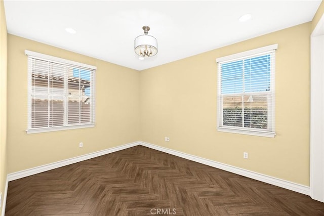 unfurnished room featuring dark parquet flooring