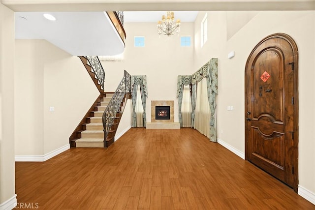 entrance foyer featuring an inviting chandelier and wood-type flooring