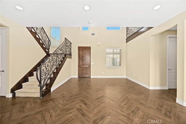 unfurnished living room with dark parquet floors