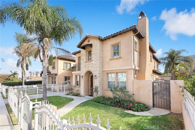 mediterranean / spanish house with a front lawn