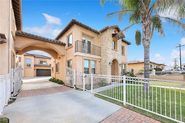 mediterranean / spanish-style house featuring a garage, a balcony, and a front lawn