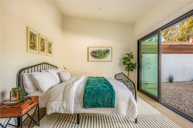 bedroom featuring access to exterior and light hardwood / wood-style floors