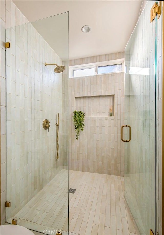 bathroom with a shower with shower door