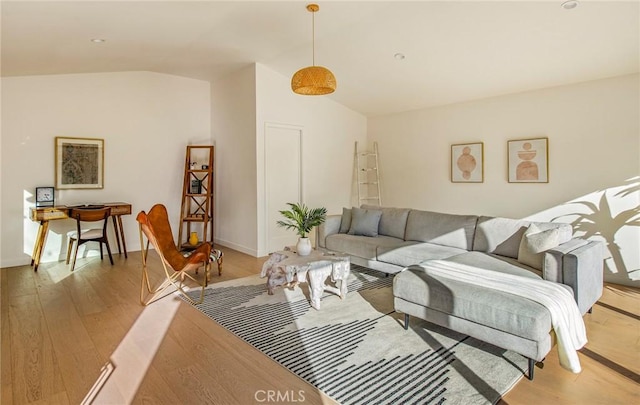 living room with vaulted ceiling and light wood-type flooring